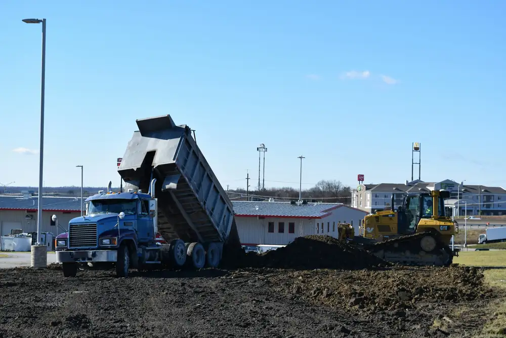Tipper truck unloading fill onto a levelled site